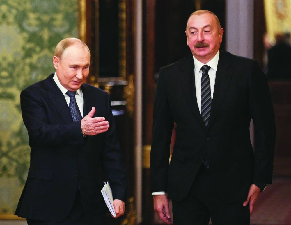 
Russian President Vladimir Putin and Azerbaijani President Ilham Aliyev enter a hall during a meeting on the sidelines of a summit of leaders of nations, which are members of the Commonwealth of Independent States (CIS), at the Kremlin in Moscow last October. (Reuters file photo) 
