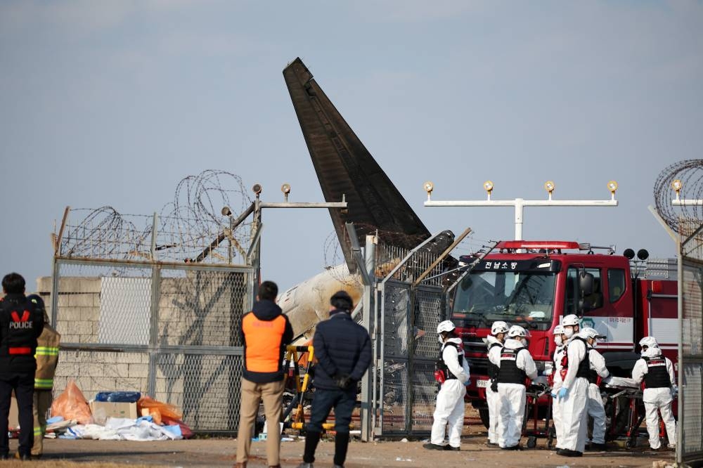 Rescue workers take part in a salvage operation at Muan International Airport. REUTERS.