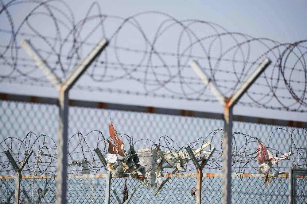 Wreckage is stuck on the fencing of the Muan International Airport after the aircraft went off the runway and crashed, on Sunday. REUTERS
