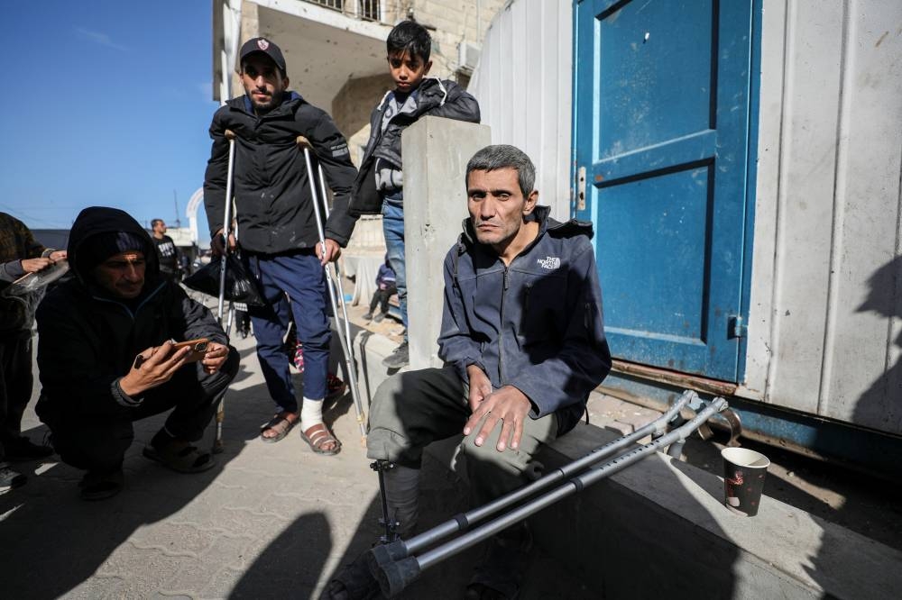 A Palestinian sits next to crutches, amid the ongoing conflict between Israel and Hamas, in Gaza City, on Saturday. REUTERS