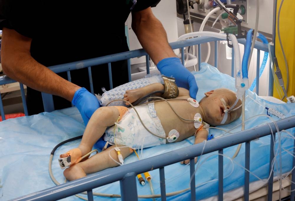 Palestinian boy Saadallah al-Balawi, who doctors said was malnourished and later passed away, lies on a bed receiving treatment at the ICU of Nasser hospital, in Khan Younis in the southern Gaza Strip on December 7. REUTERS