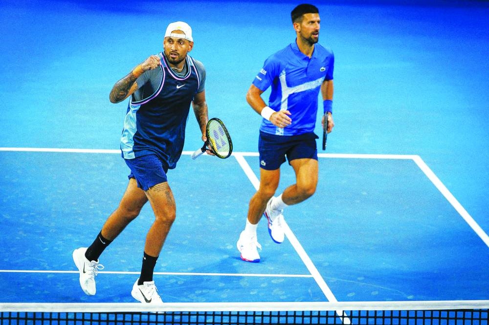 Australia’s Nick Kyrgios (left) and Serbia’s Novak Djokovic celebrate a point during their doubles match against Austraia’s Alexander Erler and Germany’s Andreas Mies in Brisbane on Monday. (AFP)