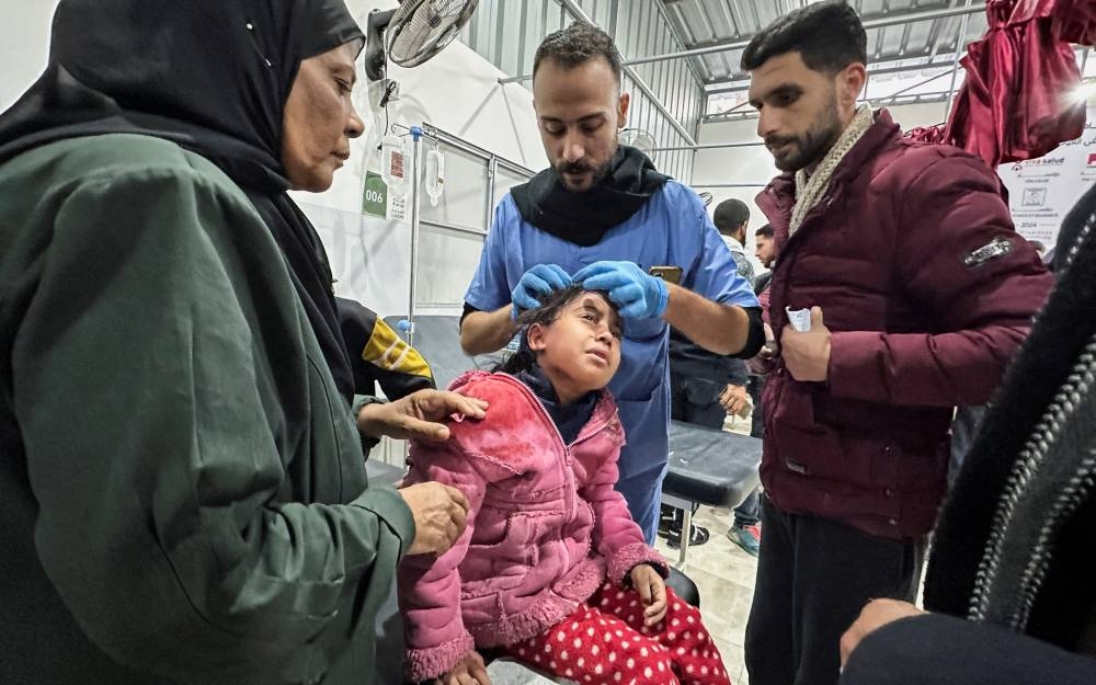 A wounded Palestinian child receives treatment at a hospital, in the aftermath of an Israeli strike, in Nuseirat in the central Gaza Strip. REUTERS