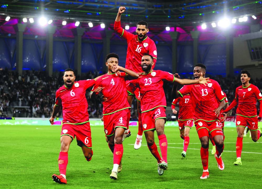 
Oman’s Arshad al-Alawi (second left) celebrates with teammates after scoring against Saudi Arabia in the semi-finals. (Reuters) 