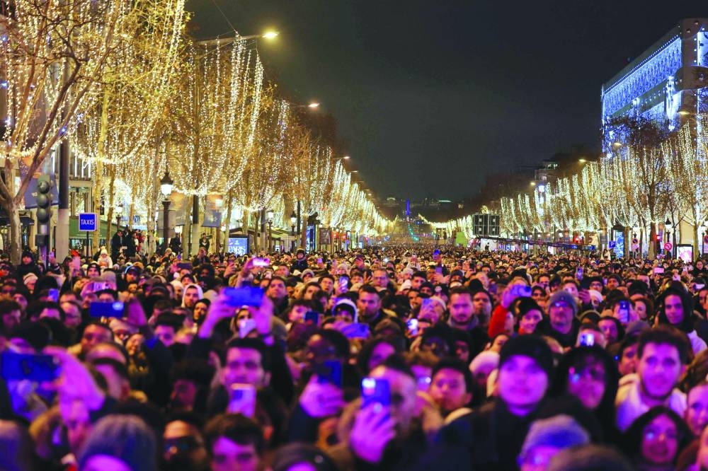 
Revellers gather on the Avenue des Champs-Elysees to welcome in the New Year in central Paris. (AFP) 