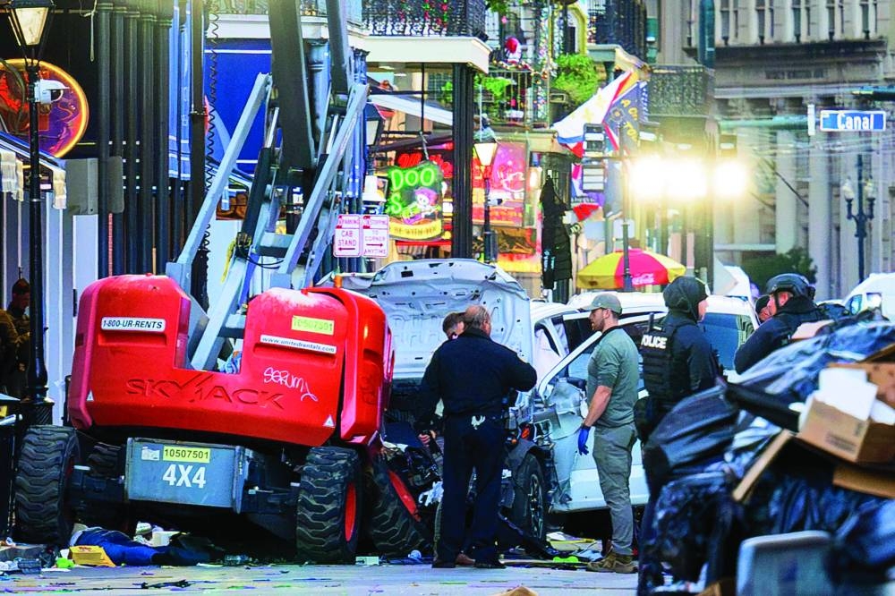Police investigators surround a white truck that has been crashed into a work lift in the French Quarter of New Orleans, Louisiana, yesterday.