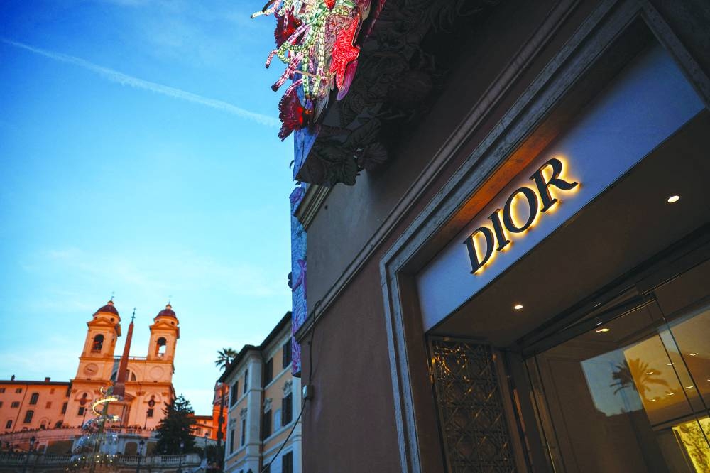 
A Dior sign is seen in a shop with the Church of Santissima Trinita dei Monti and the Spanish Steps in the background, in Rome. 
