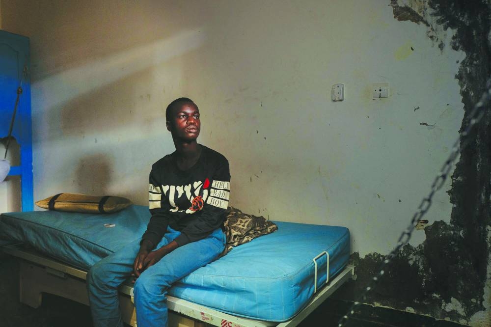 
A young man rests in his room in the psychiatry department of the CHS hospital in Nouakchott. 