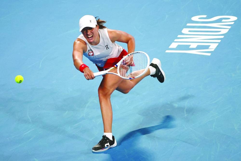 Poland’s Iga Swiatek hits a return to Britain’s Katie Boulter during their singles match at the United Cup in Sydney on Thursday. (AFP)