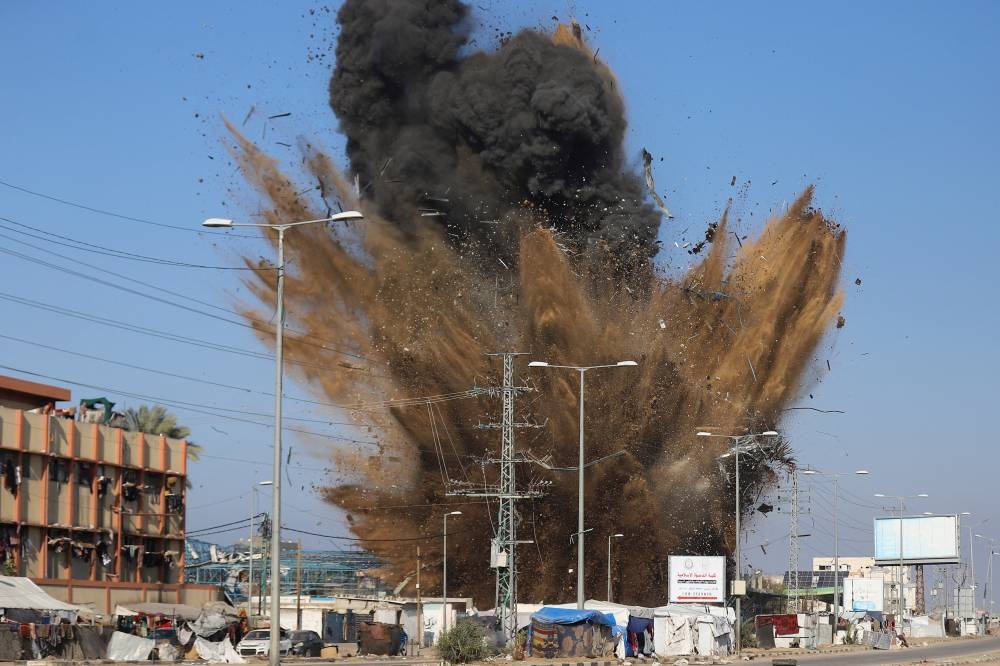 Sand and debris scatter following an Israeli strike in Deir Al-Balah in the central Gaza Strip, on Friday. REUTERS