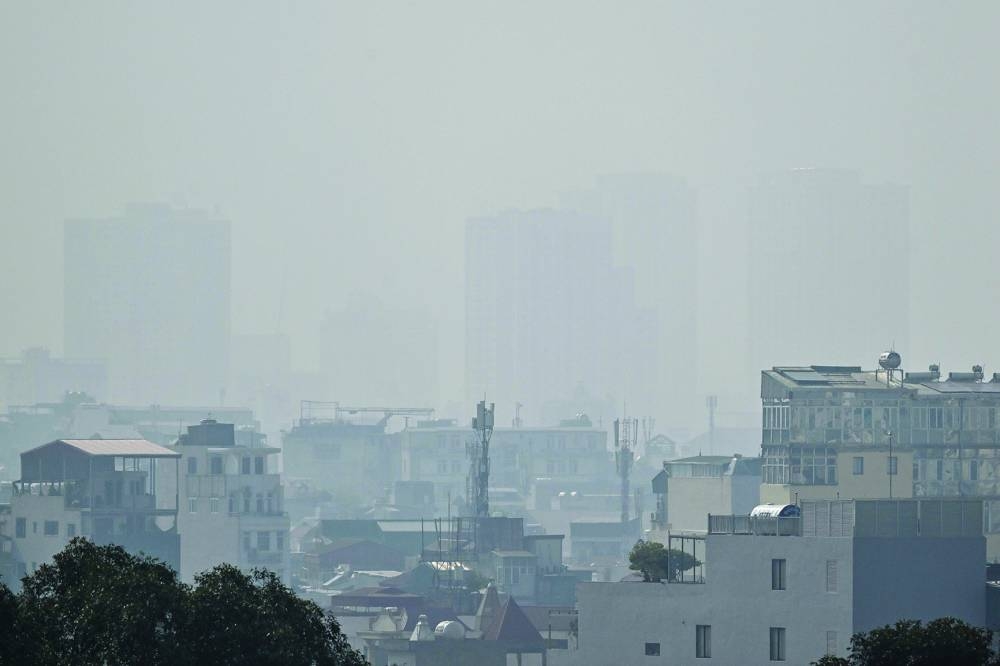 Residential buildings are shrouded behind heavy air pollution in Hanoi on Friday.