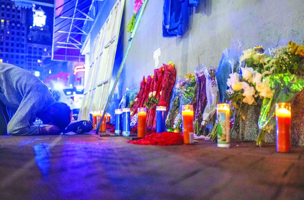 
A man reacts at a memorial on Bourbon Street after it reopened to the public. – AFP 