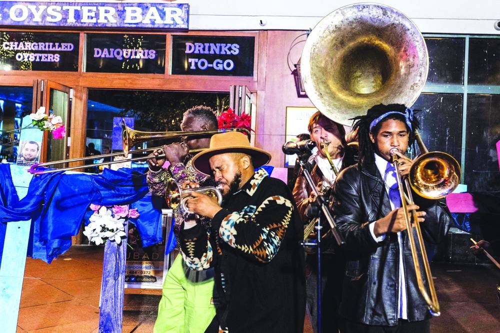 
A band plays next to crosses with pictures of victims at a memorial on Bourbon Street after it reopened to the public. – AFP 