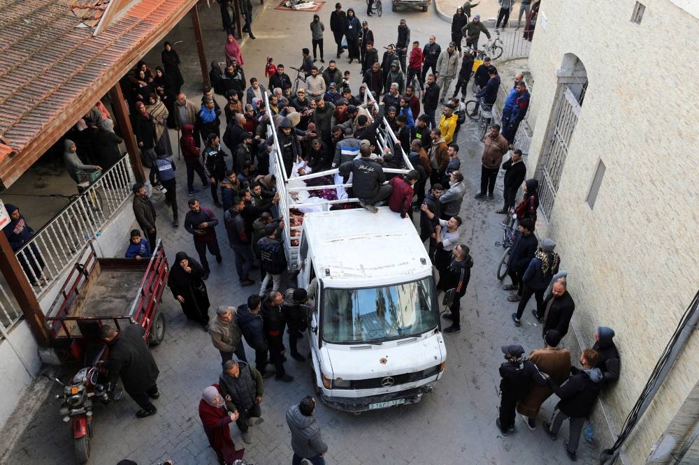 Mourners gather during the funeral of Palestinians killed in Israeli strikes at Al-Ahli Arab Baptist hospital in Gaza City, on Saturday. REUTERS