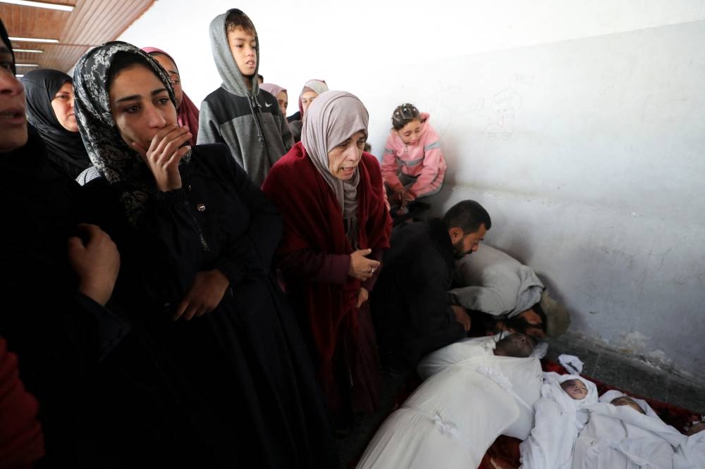 Mourners react during the funeral of Palestinians killed in Israeli strikes at Al-Ahli Arab Baptist hospital in Gaza City, on Saturday. REUTERS