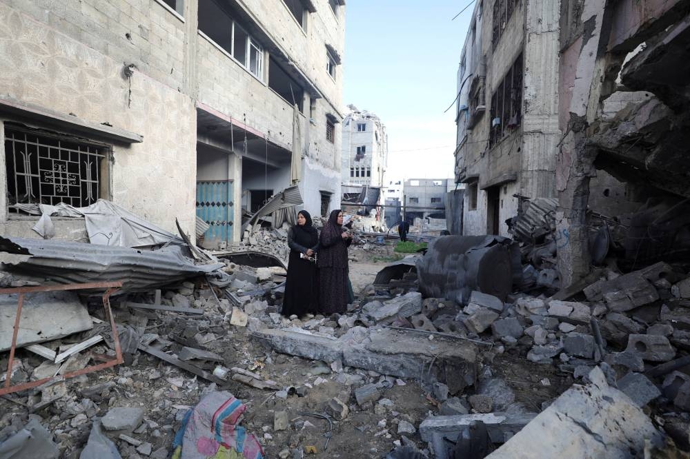 Palestinian women react at the site of an Israeli strike on a house in Gaza City, on Saturday. REUTERS