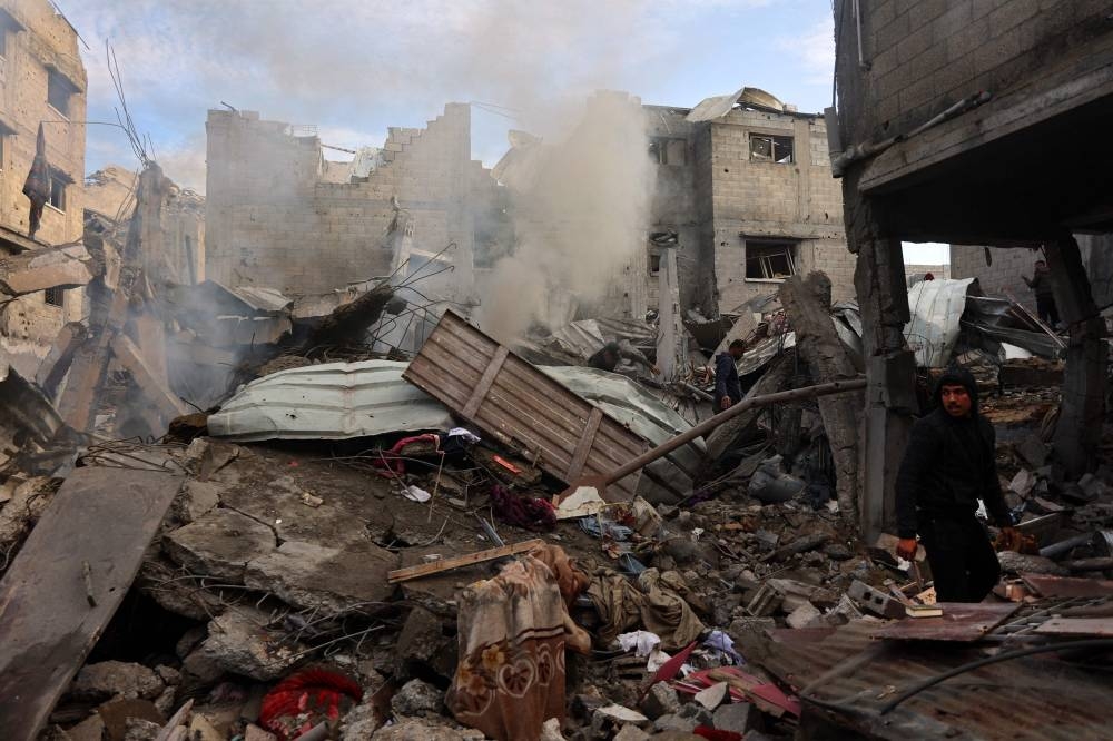 Palestinians check the destruction following an Israeli strike that hit a home in the Shujaiya neighbourhood of Gaza City, in the northern Gaza Strip on Saturday. AFP