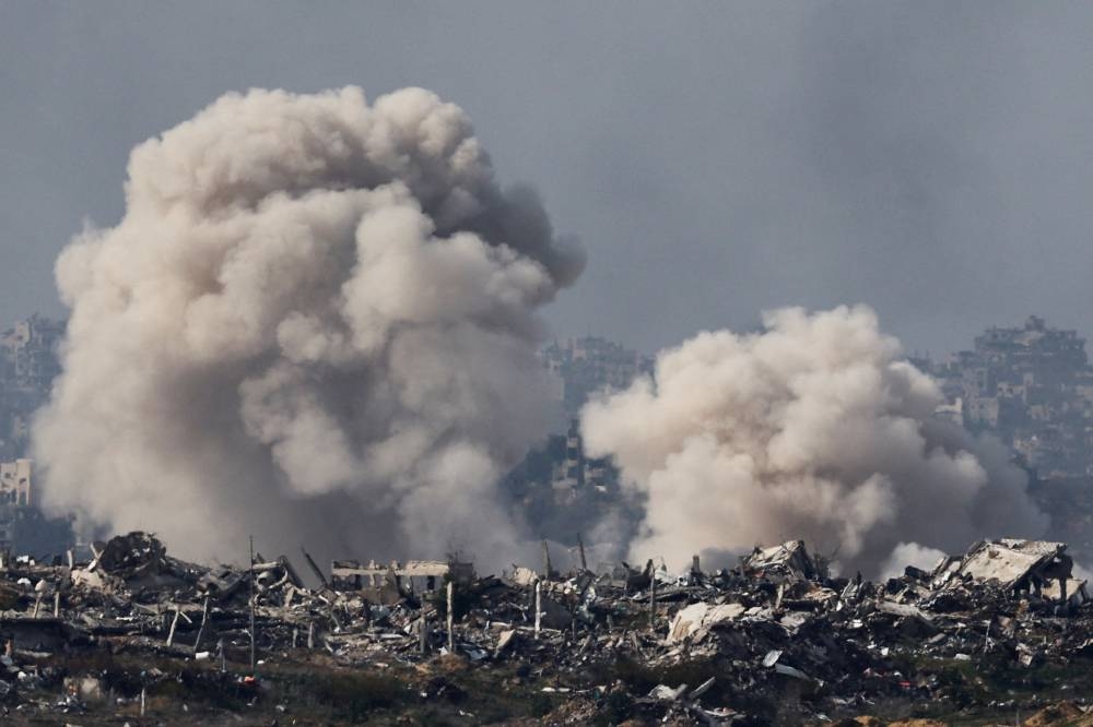 Smoke billows in the Gaza Strip, as seen from southern Israel, on Sunday. REUTERS
