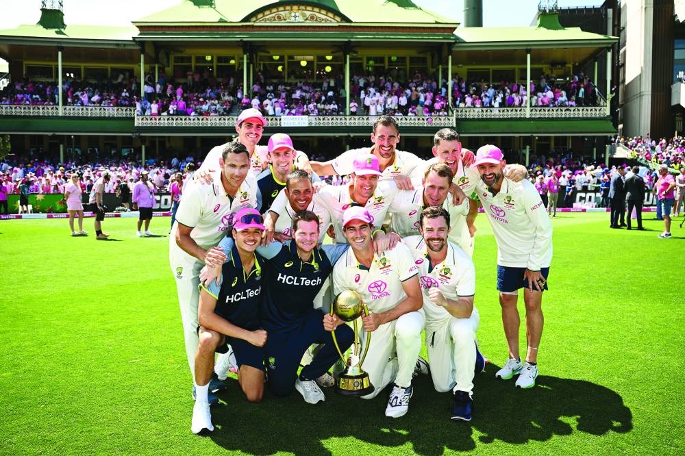 
Australia players celebrate with the Border-Gavaskar Trophy after winning the Test series against India following the fifth Test at the Sydney Cricket Ground yesterday. (Reuters) 