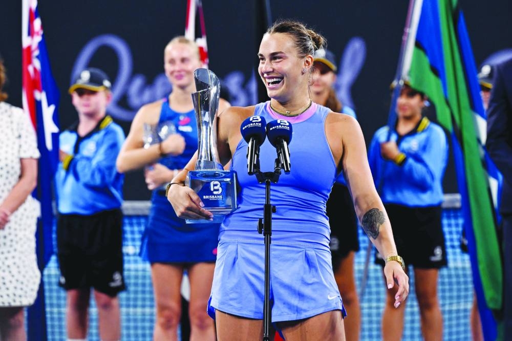 Aryna Sabalenka of Belarus laughs as she holds her trophy after the singles final match against Polina Kudermetova of Russia at the Brisbane International at Pat Rafter Arena in Brisbane yesterday. (AFP)