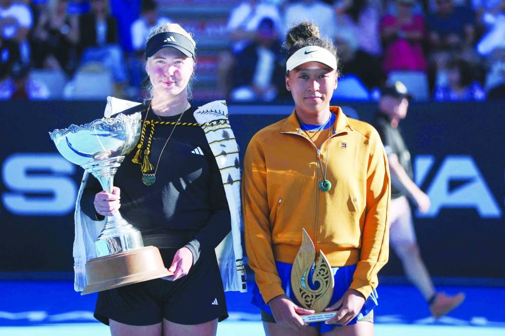 Clara Tauson of Denmark (left) celebrates with the trophy after her win over Naomi Osaka of Japan following the latter’s retirement from their singles final match due to an abdominal injury at the WTA Auckland Classic yesterday. (AFP)