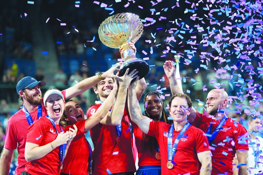 United States captain Michael Russell is seen with Taylor Fritz, Coco Gauff and teammates as they celebrate with the trophy after winning the United Cup final against Poland at the Ken Rosewall Arena, Sydney, Australia, yesterday. (Reuters)