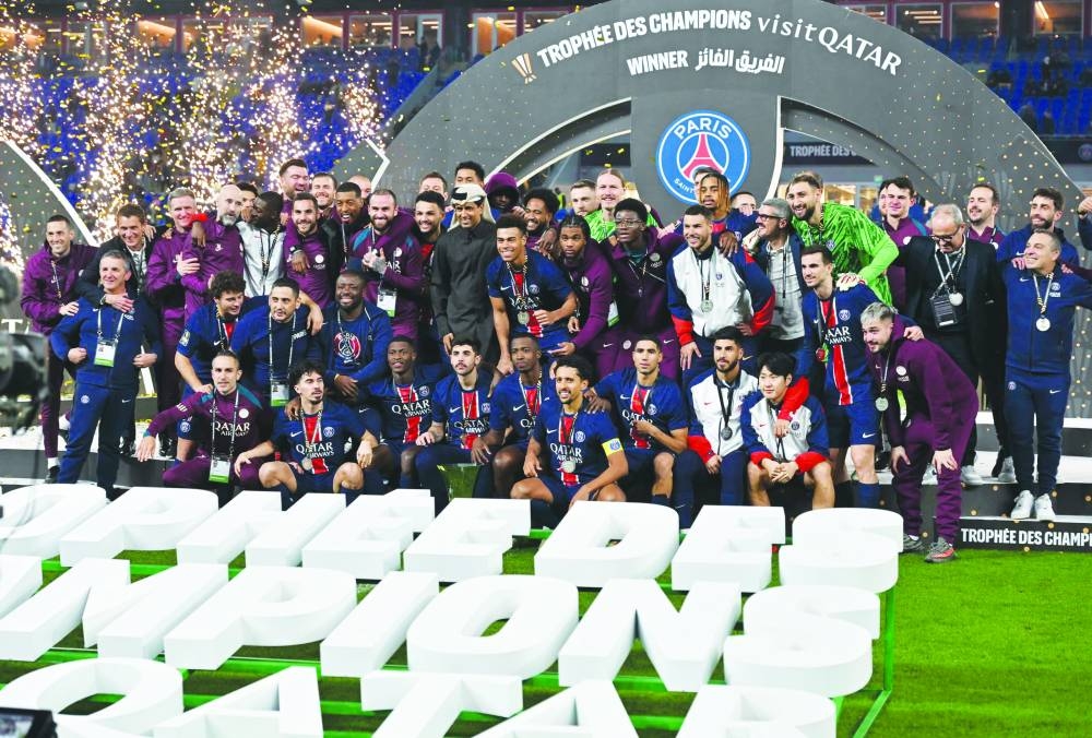 
PSG president Nasser al-Khelaifi and players celebrate with the trophy after the club won the Trophee des Champions at the Stadium 974 in Doha yesterday. PICTURES: Noushad Thekkayil 