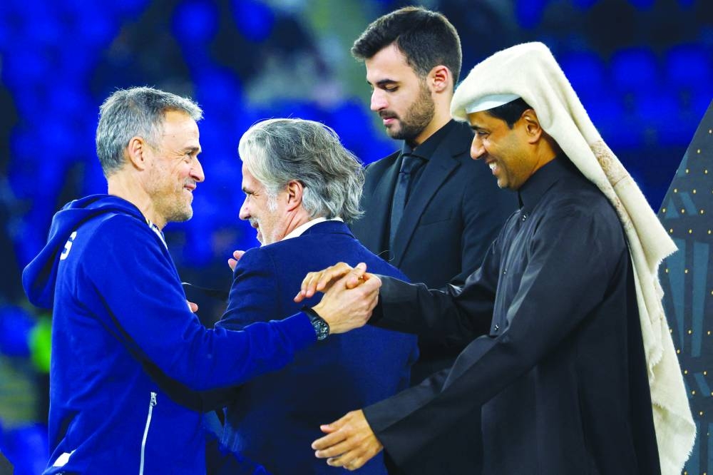 
PSG coach Luis Enrique shakes hands with the club president Nasser al-Khelaifi after their victory yesterday. 