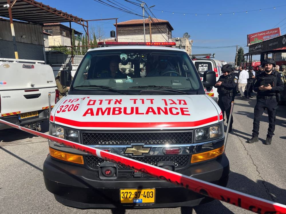 Israeli security and rescue personnel at the scene of a shooting attack on a car and bus where at least three Israelis were killed near Kedumim in the Israeli-occupied West Bank, on Monday. REUTERS
