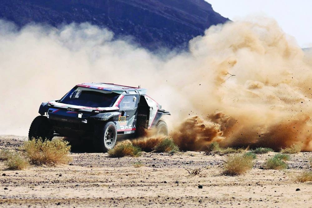 
Qatari driver Nasser al-Attiyah and his navigator France’s Edouard Boulanger in action on their Dacia Sandrider during stage 3 of the 47th Dakar Rally between Bisha and Al Henakiyah in Saudi Arabia yesterday. (AFP) 