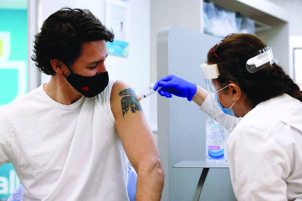Canadian Prime Minister Justin Trudeau being inoculated with AstraZeneca’s vaccine against coronavirus disease at a pharmacy in Ottawa, Ontario, on April 23, 2021. (Reuters) 