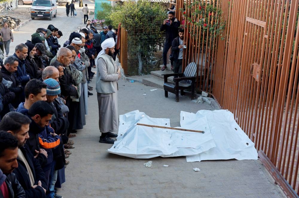 Mourners perform funeral prayers near the bodies of Palestinians killed in Israeli strikes, in Khan Younis, in the southern Gaza Strip, on Wednesday. REUTERS