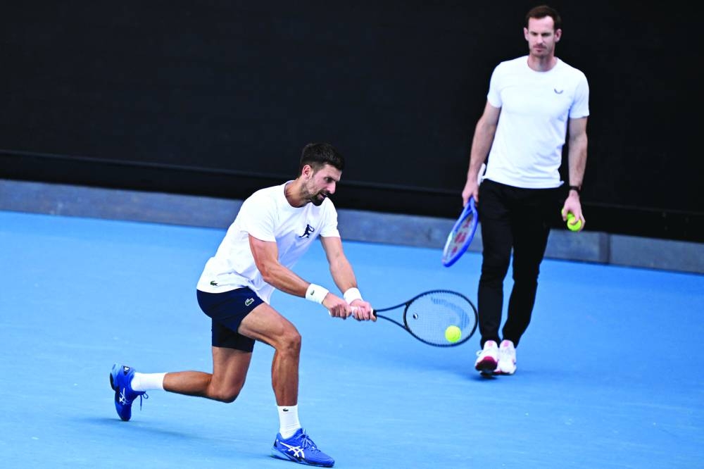 
Novak Djokovic of Serbia (left) hits a return as coach Andy Murray looks on during a training session ahead of Australian Open in Melbourne. (AFP) 