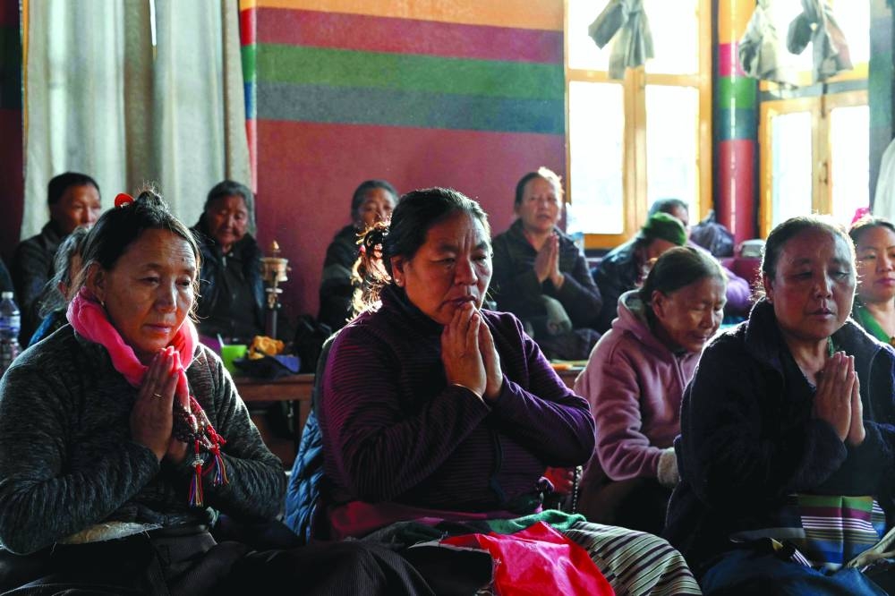 
Tibetan exiles living in Nepal pray for the victims and survivors of the 7.1-magnitude earthquake in southwestern China’s Tibet region. 