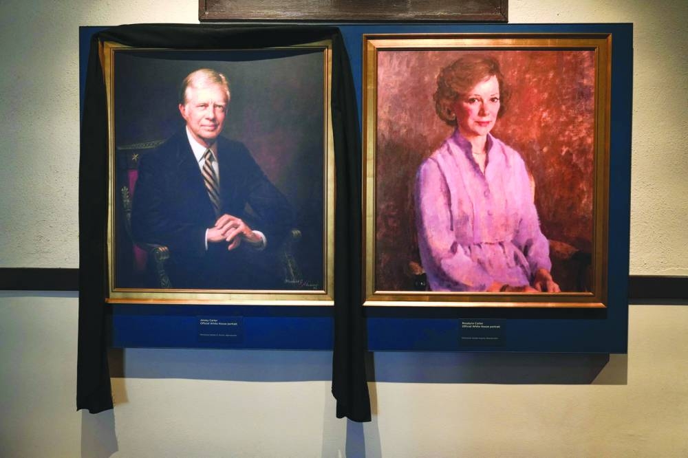 
A black cloth hangs over the portrait of former president Jimmy Carter at the Jimmy Carter National Historical Park in Plains, Georgia. – AFP 