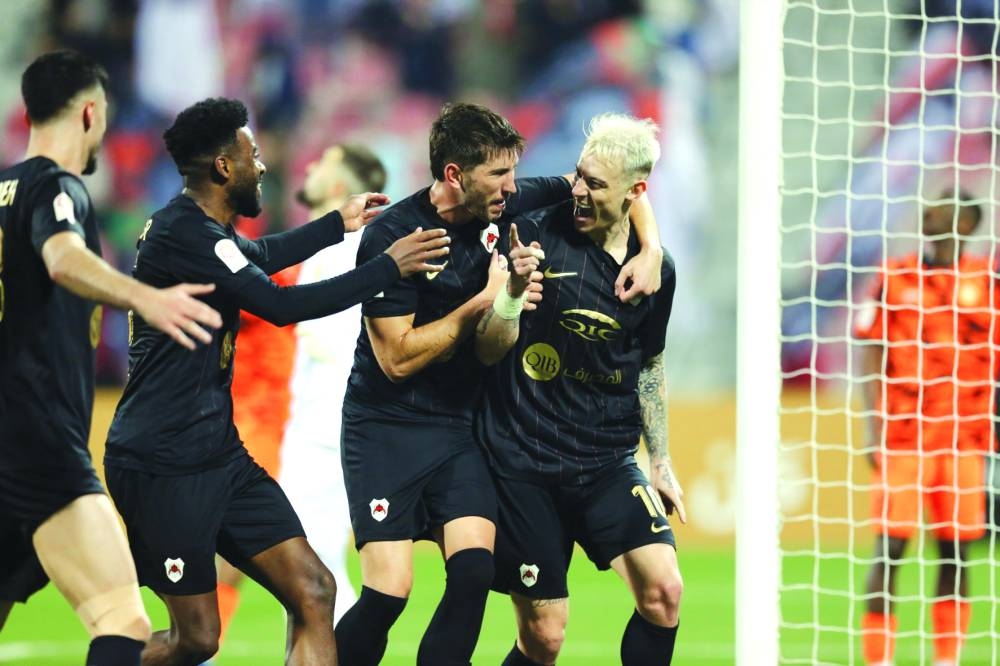 Al Rayyan’s Roger Guedes (right) celebrates with teammates after scoring against Umm Salal at the Grand Hamad Stadium on Friday.