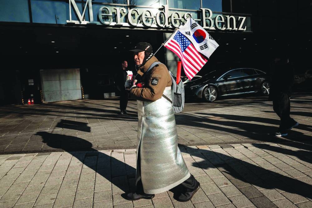 
A supporter of the impeached South Korean President Yoon Suk-yeol walks near his residence in Seoul. 