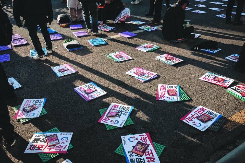 
Posters and hand warmers are prepared before a rally against the impeached president near his residence in Seoul. 