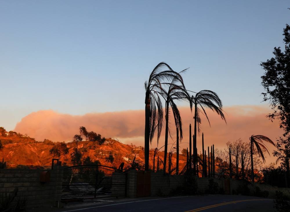 Smoke rises over the hills from the Palisades Fire in Malibu, California, on Friday. REUTERS