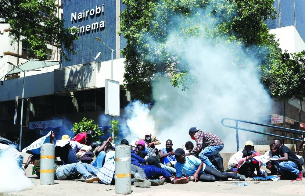 
Protesters, demonstrating against what they say is a wave of unexplained abductions of government critics, react after riot police lobbed tear gas canisters to disperse them along the Aga Khan walk in downtown Nairobi last month. (Reuters) 