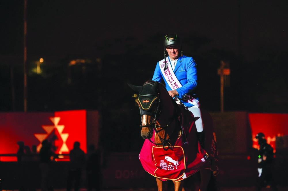 
Austria’s Gerfried Puck celebrates with stallion Equitron Naxcel V after winning the CSI4*Grand Prix at the Doha International Equestrian Tour in Al Shaqab. 