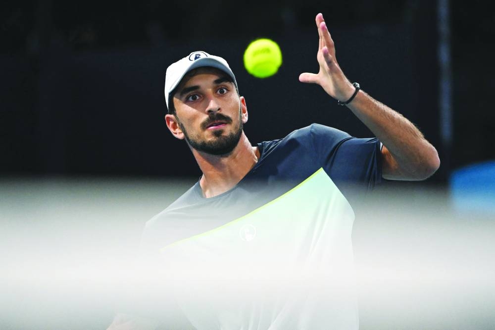 
Lebanon’s Hady Habib eyes the ball as he hits a shot against China’s Bu Yunchaokete during their singles match on day one of the Australian Open in Melbourne yesterday. (AFP) 