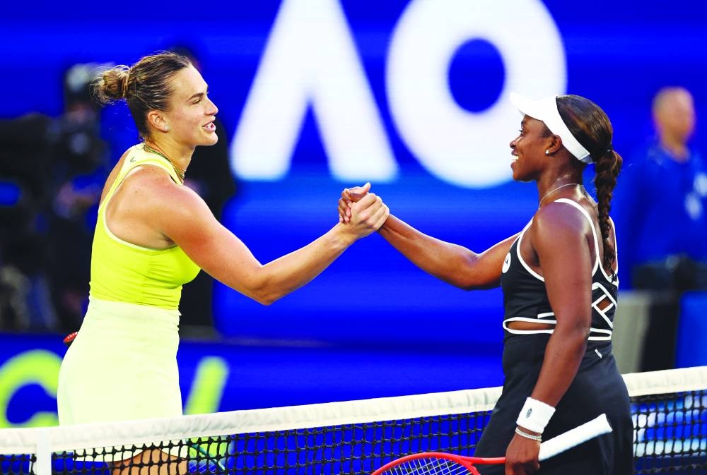 Belarus’ Aryna Sabalenka shakes hands with Sloane Stephens of the US after winning her first round match at the Australian Open in Melbourne yesterday. Right: Germany’s Alexander Zverev hits a shot against France’s Lucas Pouille during their singles match yesterday. (Reuters/AFP)