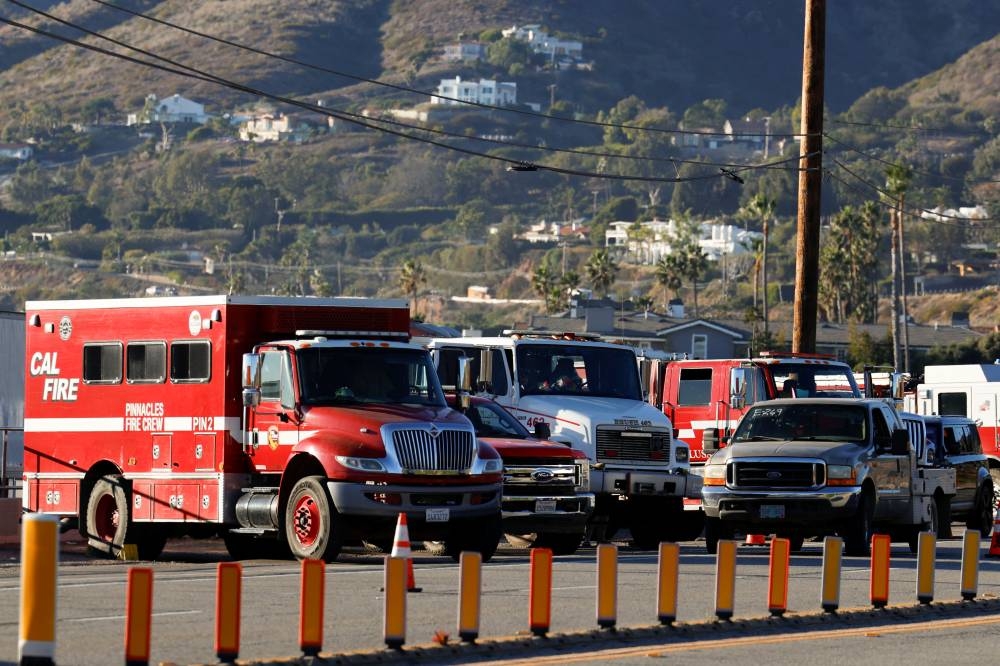 Emergency crews vehicles park along Pacific Coast Highway at Zuma Beach, following wildfires, in Malibu, California, on Sunday. REUTERS