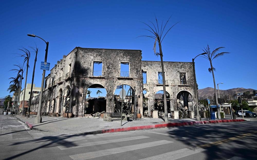 A building that once housed restaurants and coffee shops among other businesses  is seen destroyed by the Palisades Fire in Pacific Palisades, California, on Sunday. AFP