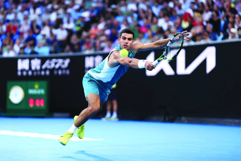 Spain’s Carlos Alcaraz hits a return against Kazakhstan’s Alexander Shevchenko during their singles match on Monday. (AFP)