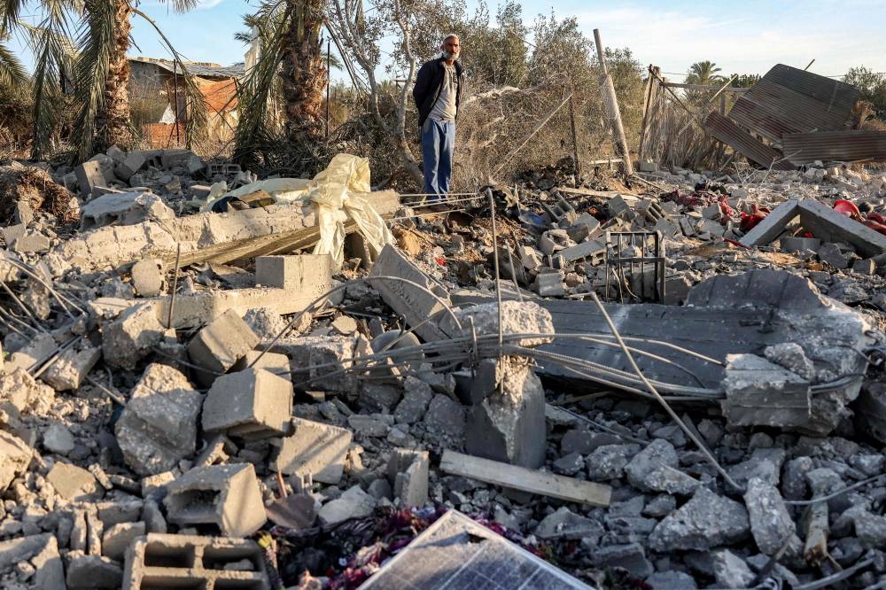 A man inspects the remains of a site that was hit by Israeli bombardment east of Khan Yunis in the southern Gaza Strip, on Tuesday. AFP