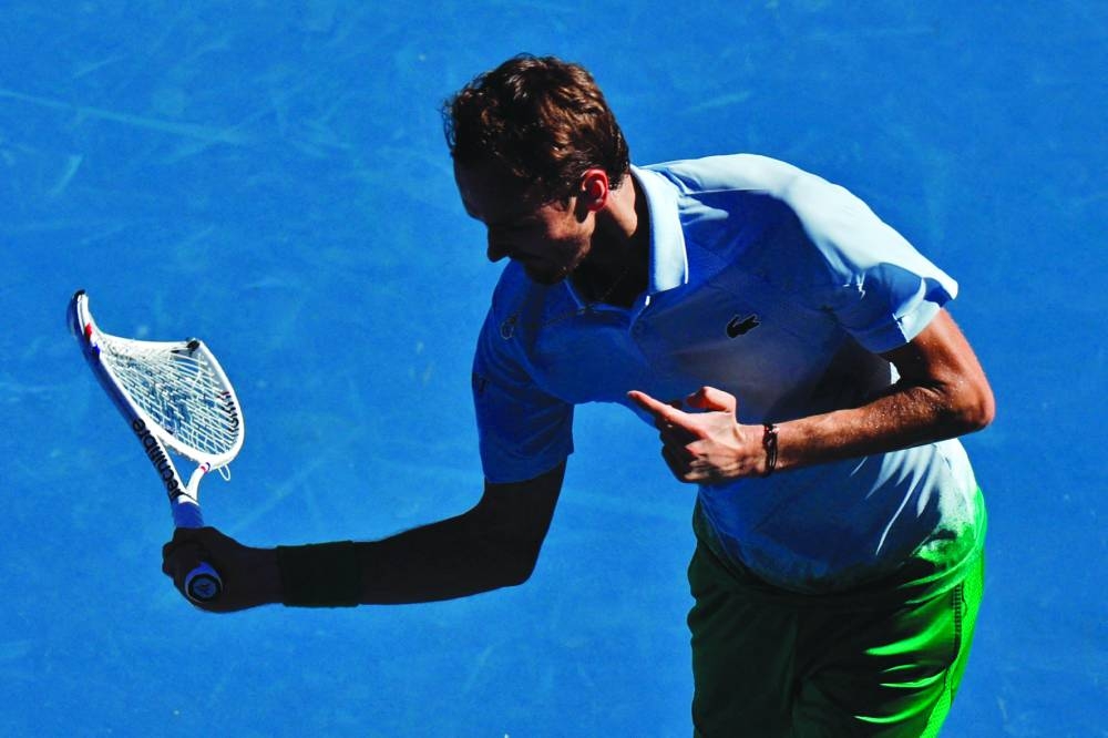 Russia’s Daniil Medvedev reacts while holding his smashed racquet during his Australian Open first round match against Thailand’s Kasidit Samrej in Melbourne on Tuesday. (Reuters)