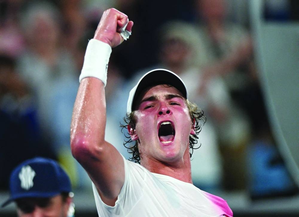 Brazil’s Joao Fonseca celebrates after winning his Australian Open first round match against Russia’s Andrey Rublev on Tuesday. (Reuters)
