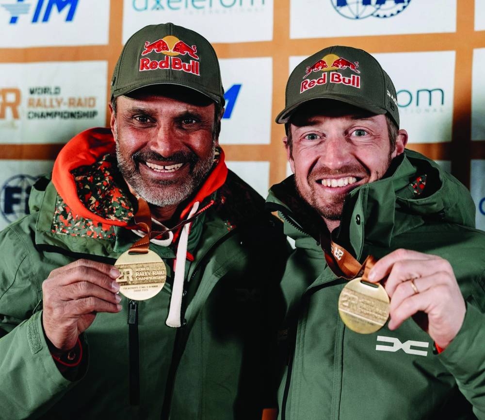 
Qatar’s Nasser al-Attiyah and French co-driver Edouard Boulanger celebrate with their medals after winning the stage 9 of the Dakar Rally in Haradh, Saudi Arabia. 